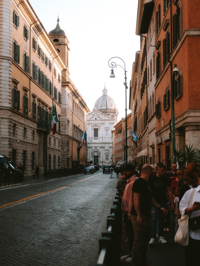A group of people standing on the side of a street