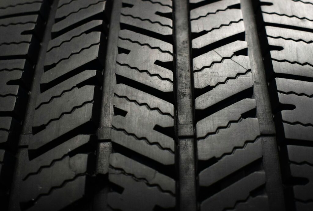 A close up of a tire on a black background