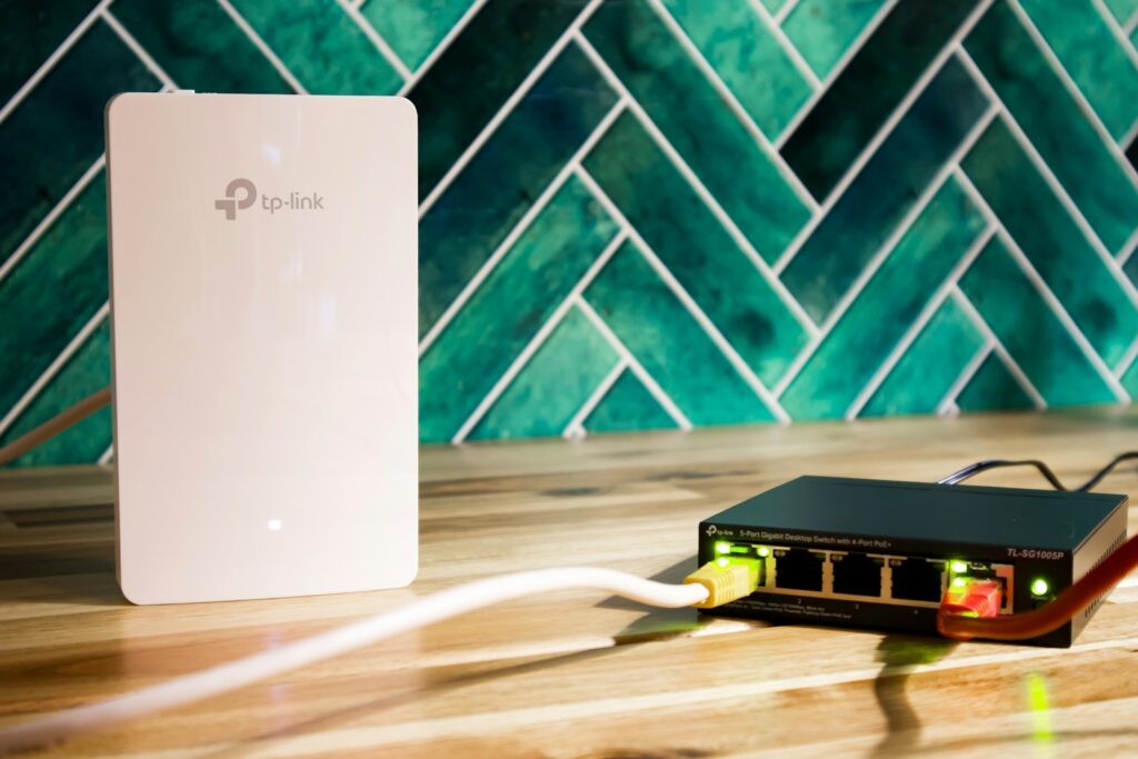A wi-fi router and a network switch sit side-by-side.