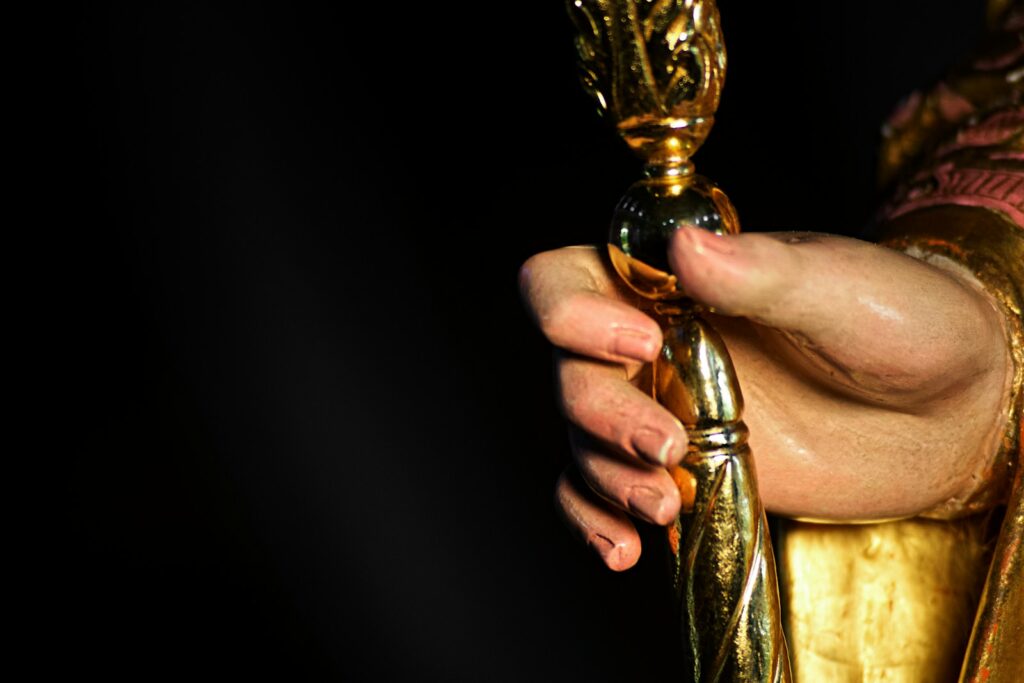 A close up of a person holding a golden object