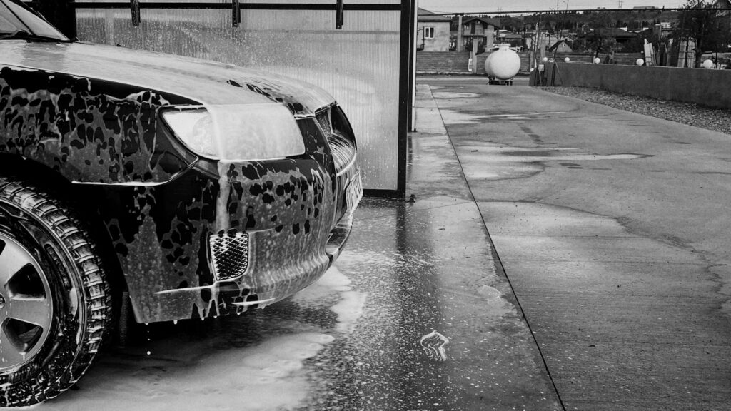 grayscale photo of car on road