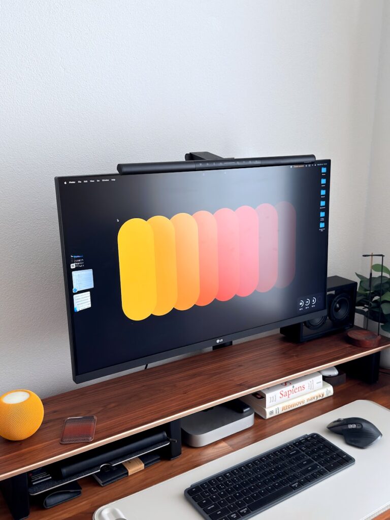 Modern desk setup with computer monitor and keyboard.
