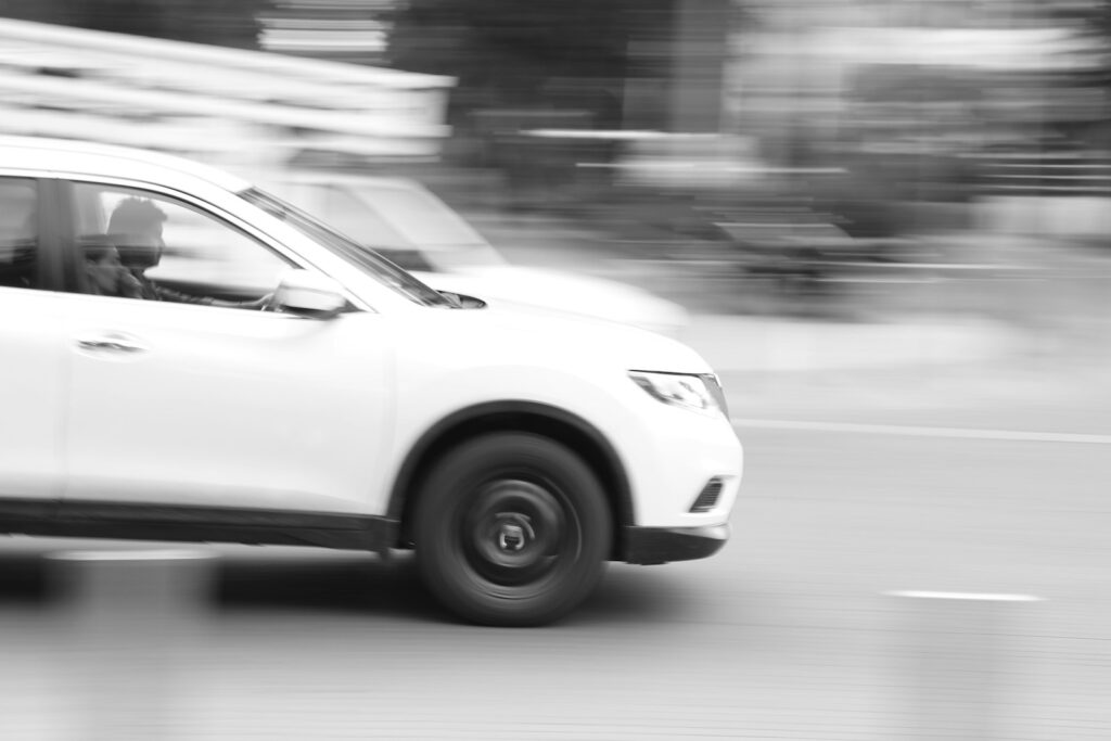 a white car driving on a road