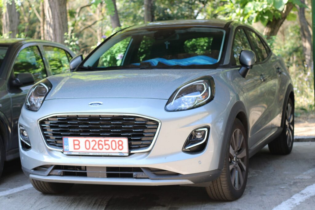 two cars parked next to each other in a parking lot