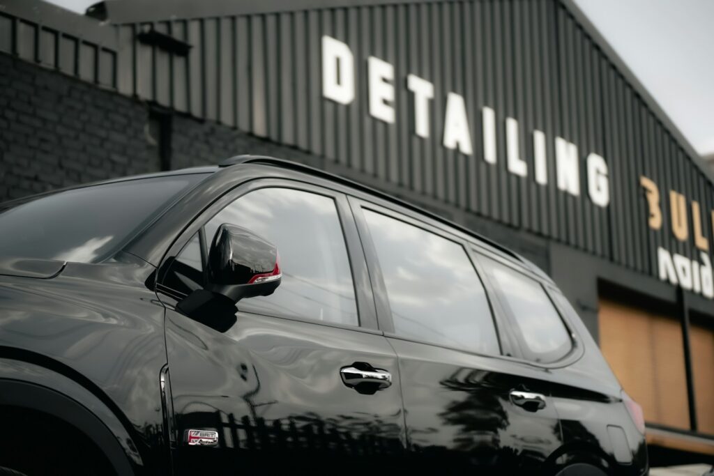 a black suv parked in front of a building