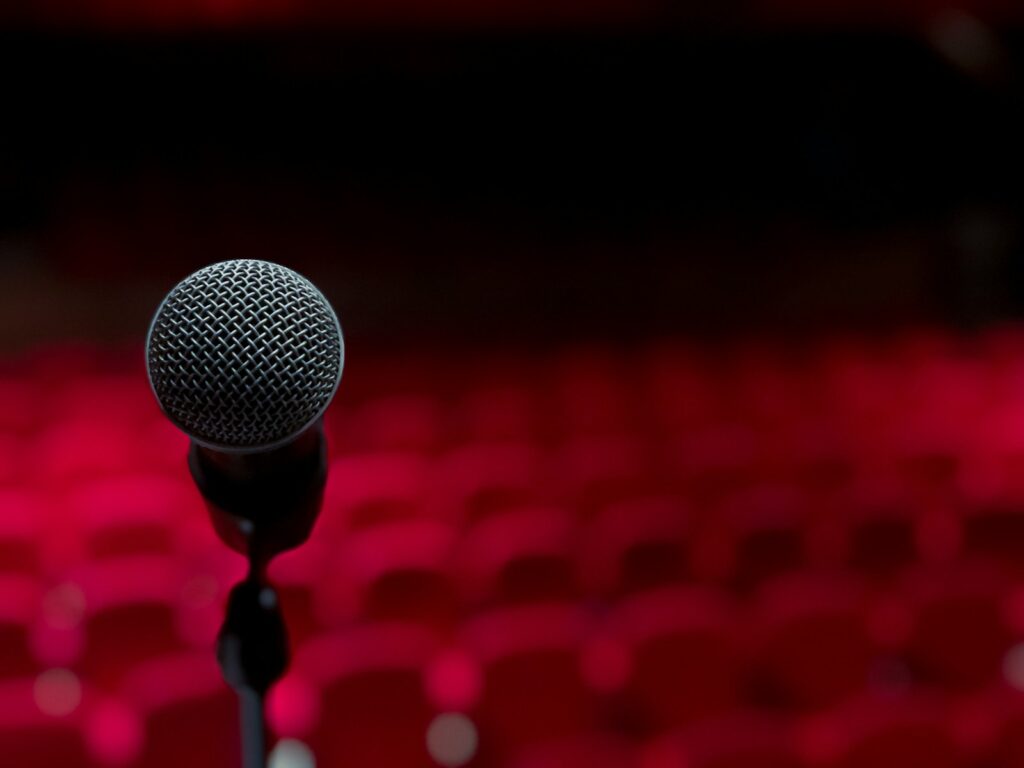 a microphone on a stand in front of a red background