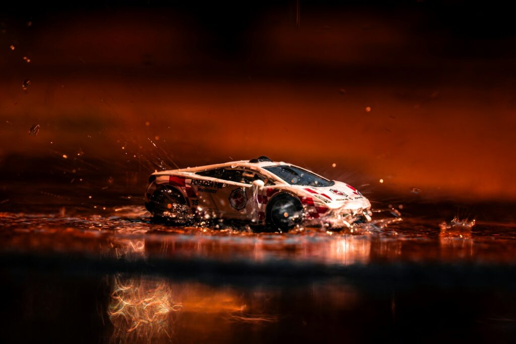A car that is in the water with it's hood up