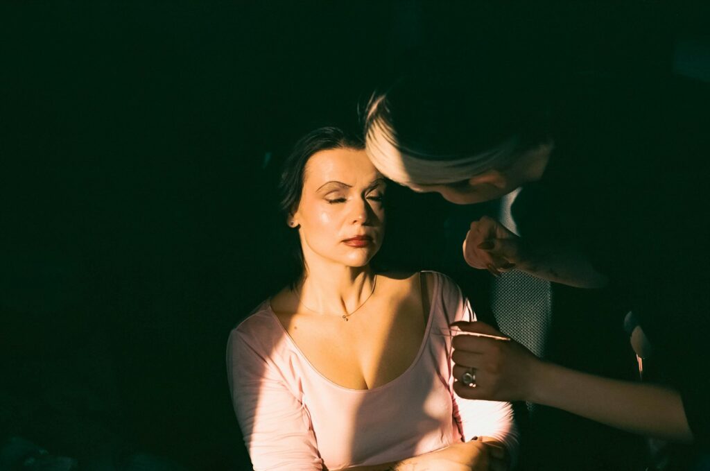 a woman getting her hair done by a hair stylist