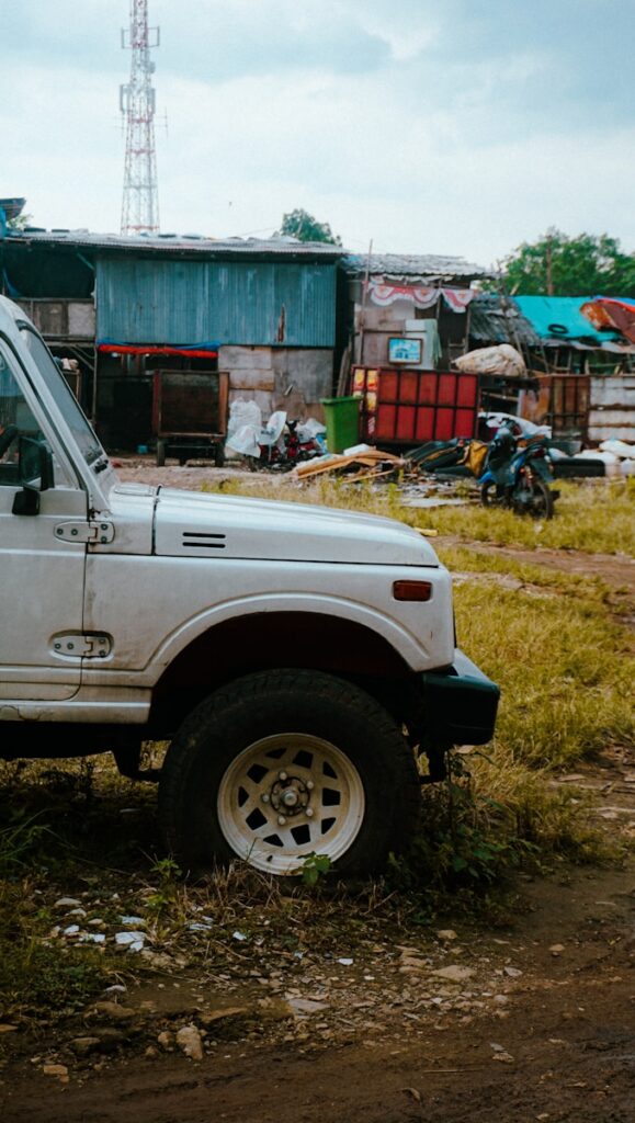 a white truck parked in front of a shack