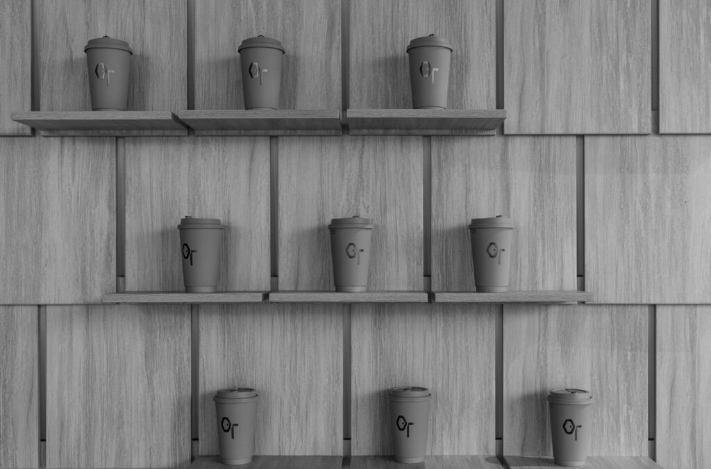 a black and white photo of coffee cups on shelves
