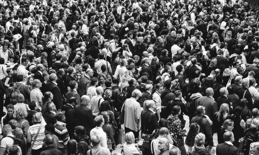 grascale photo of people standing on ground
