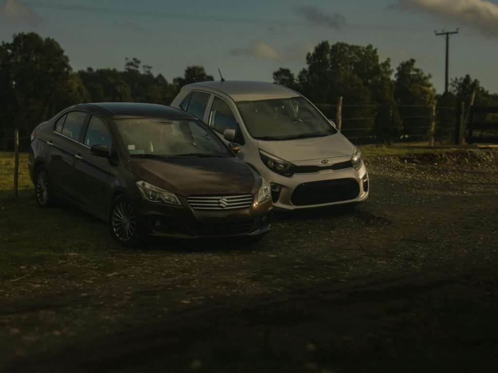 Two cars parked on a dirt road