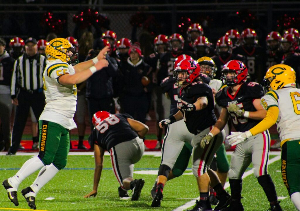 a group of football players playing a game of football