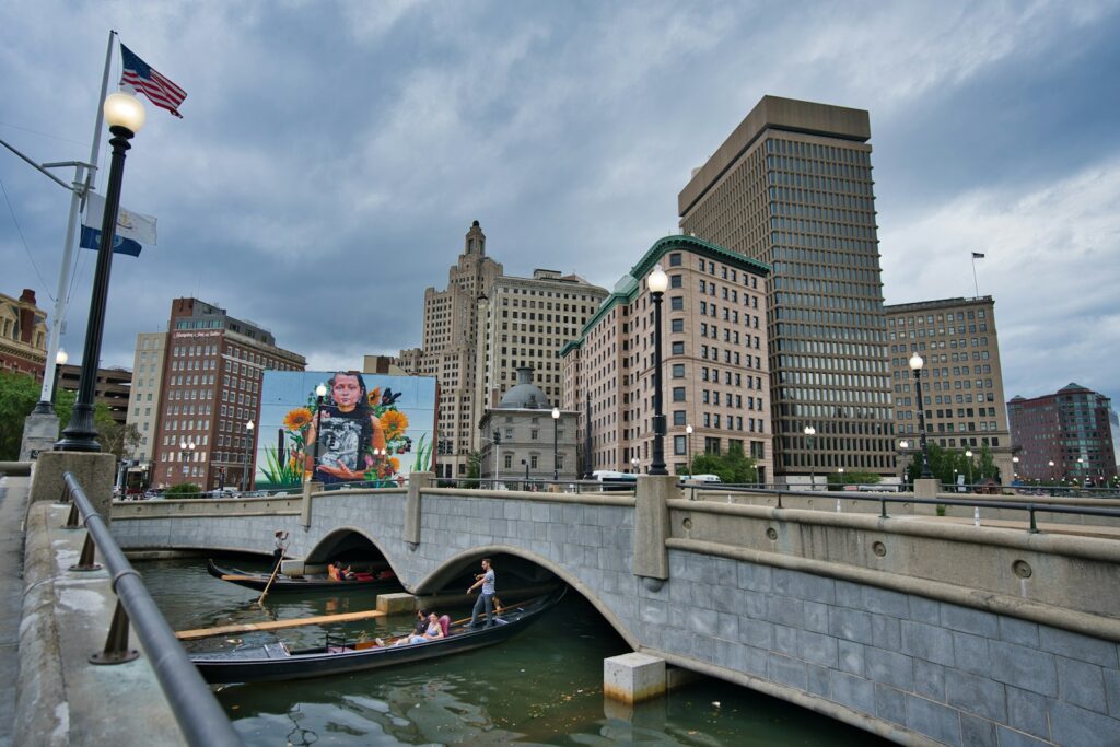 a bridge over a river with a city in the background