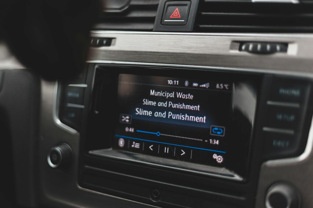 a car dashboard with a radio and a remote control