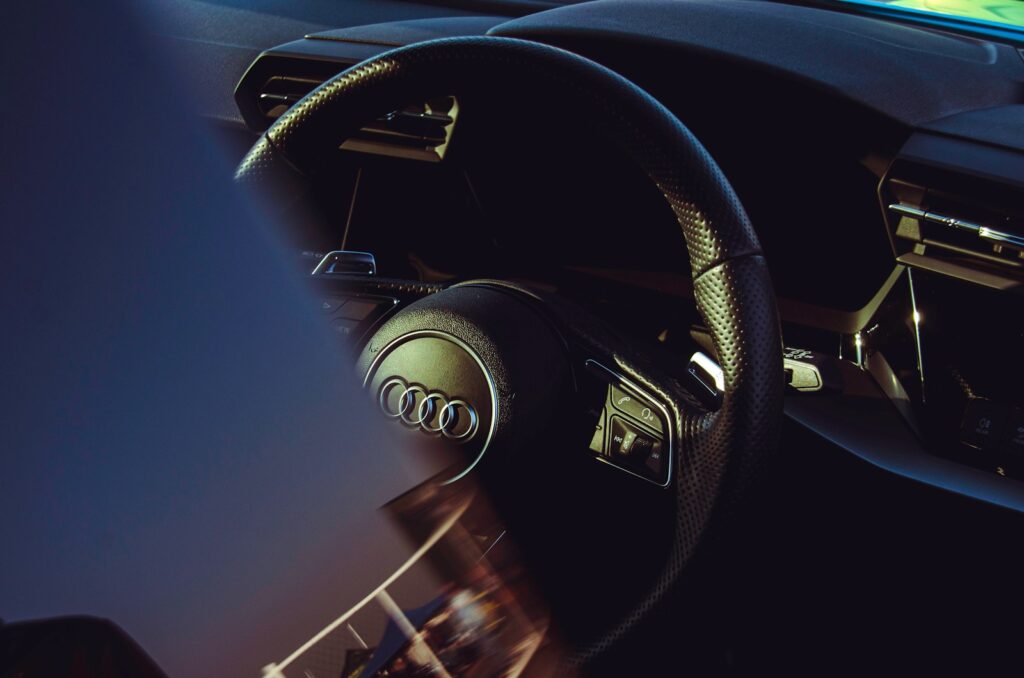 A car's steering wheel is visible.