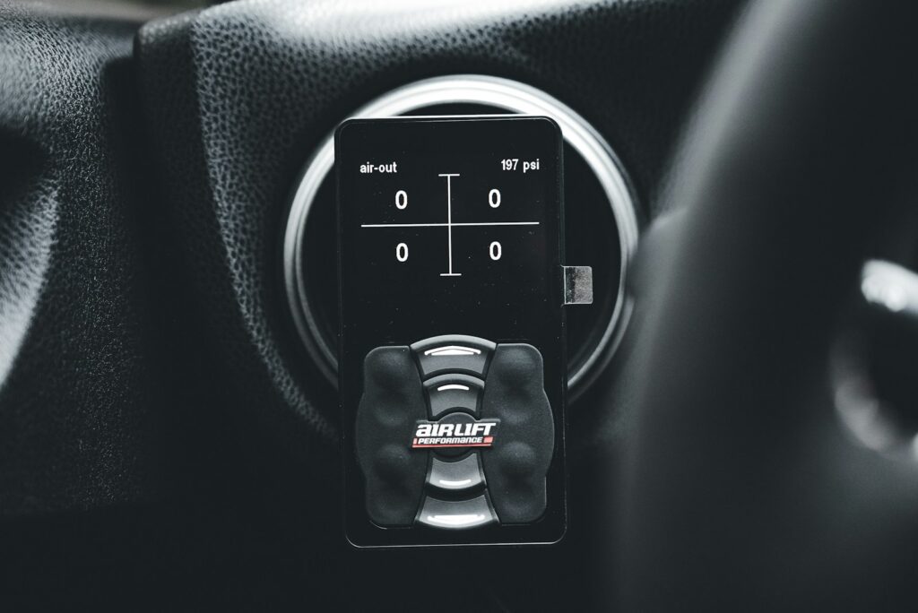 A close up of a car's steering wheel controls