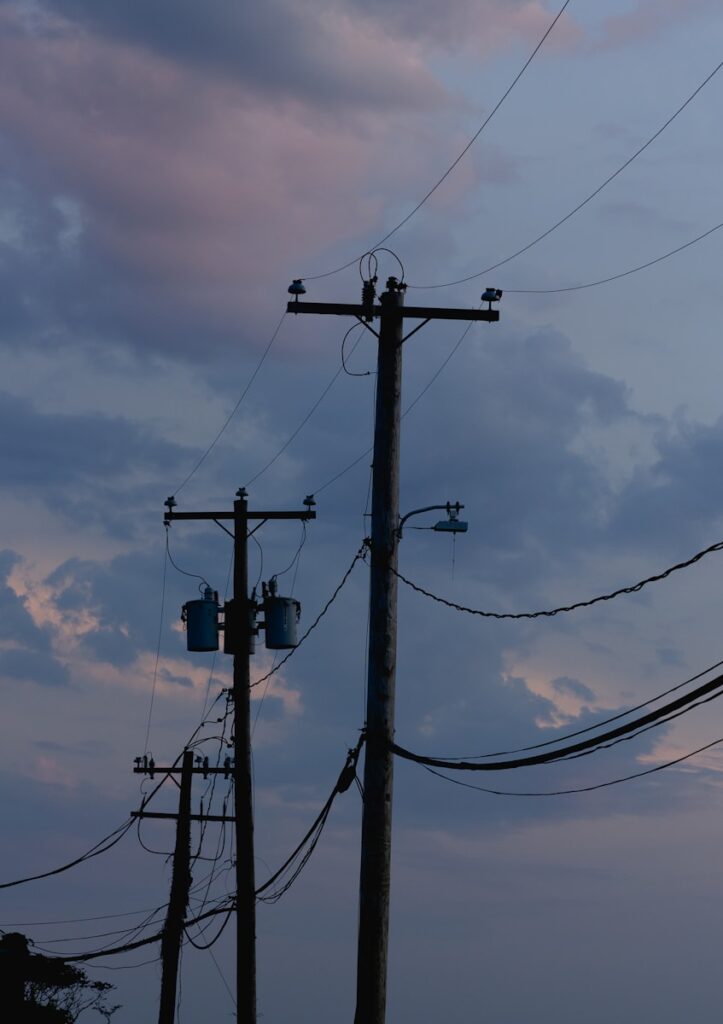 power lines and telephone poles against a cloudy sky