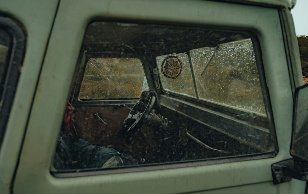 a green truck with a mirror on the side of it