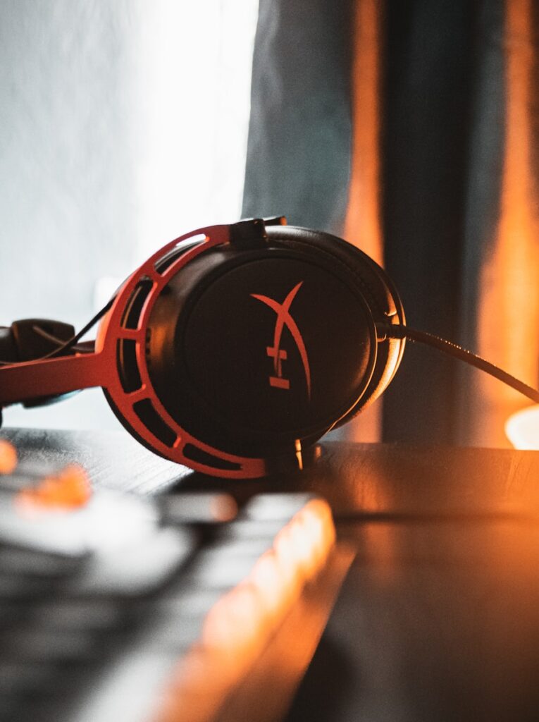 black and red headphones on brown wooden table