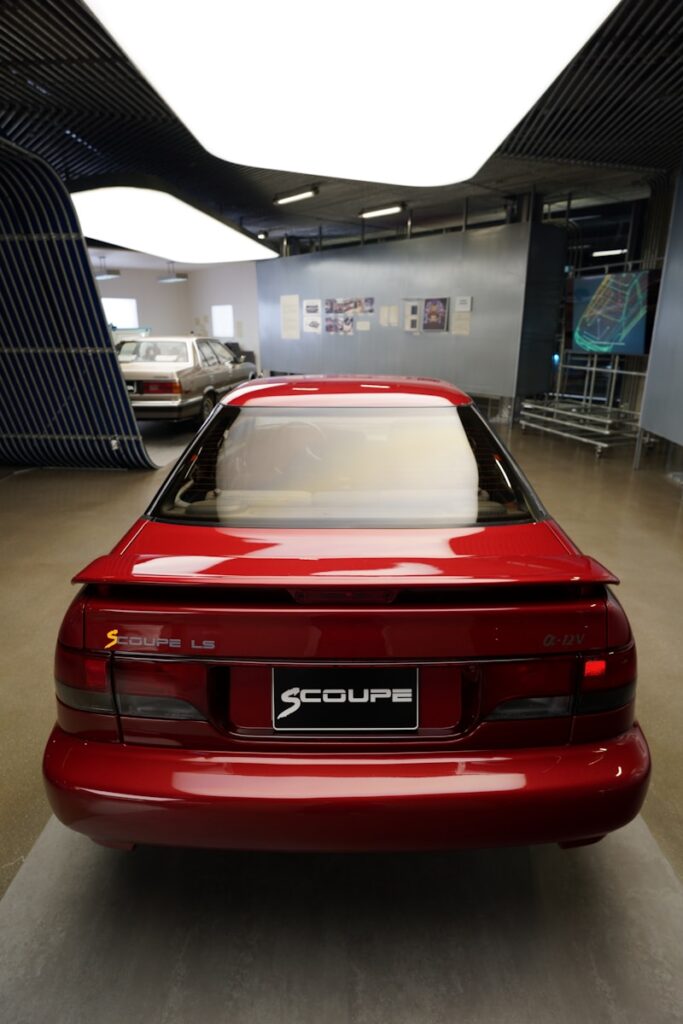 A red sports car parked in a garage