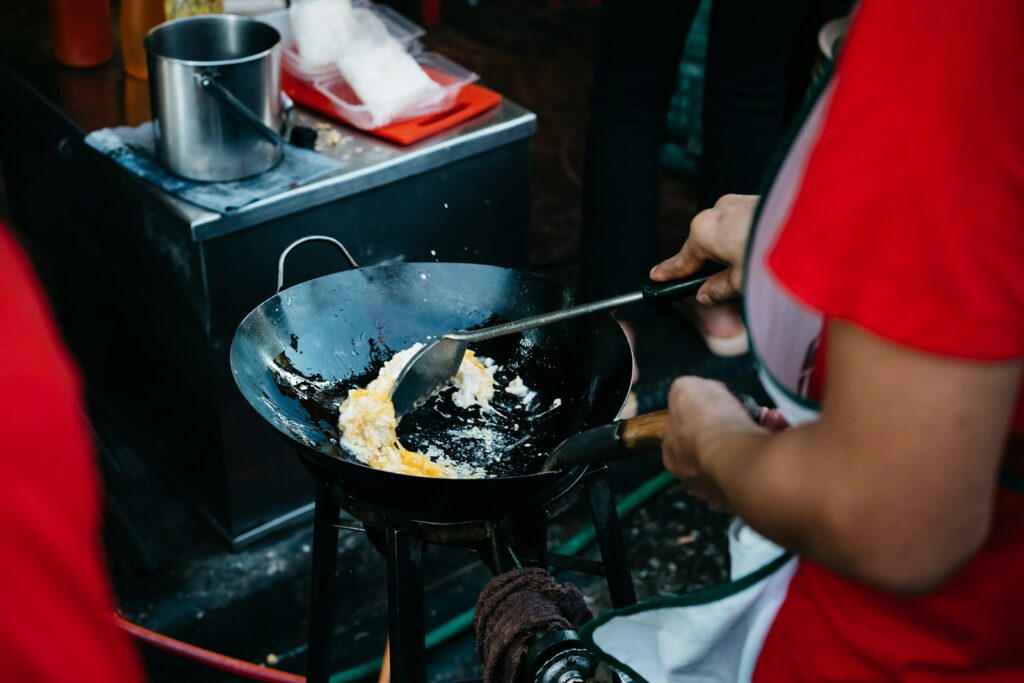a person cooking food on a small stove