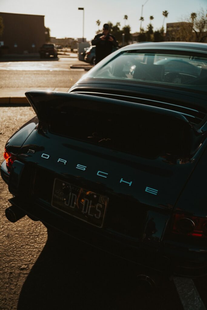 A black porsche is parked and ready.