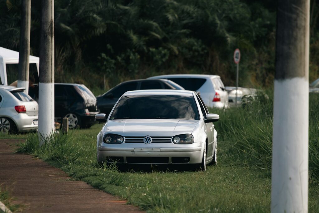A white car parked on the side of a road