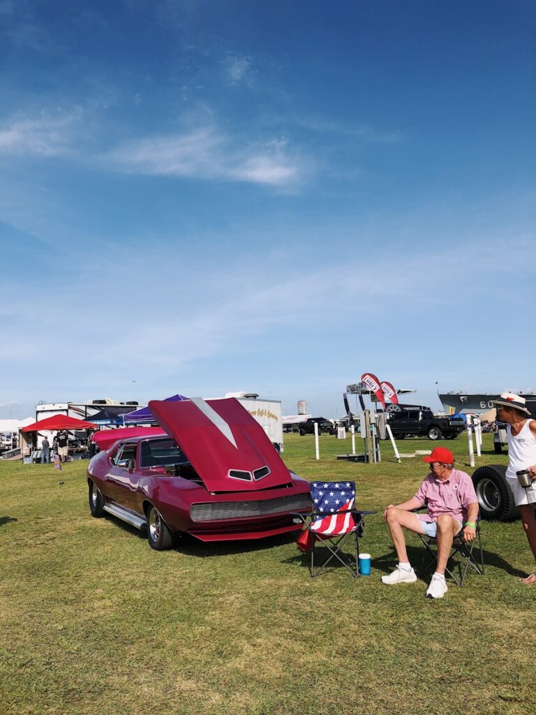 red and blue camping chairs on green grass field during daytime