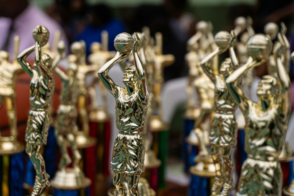 Rows of golden trophies displayed at an event