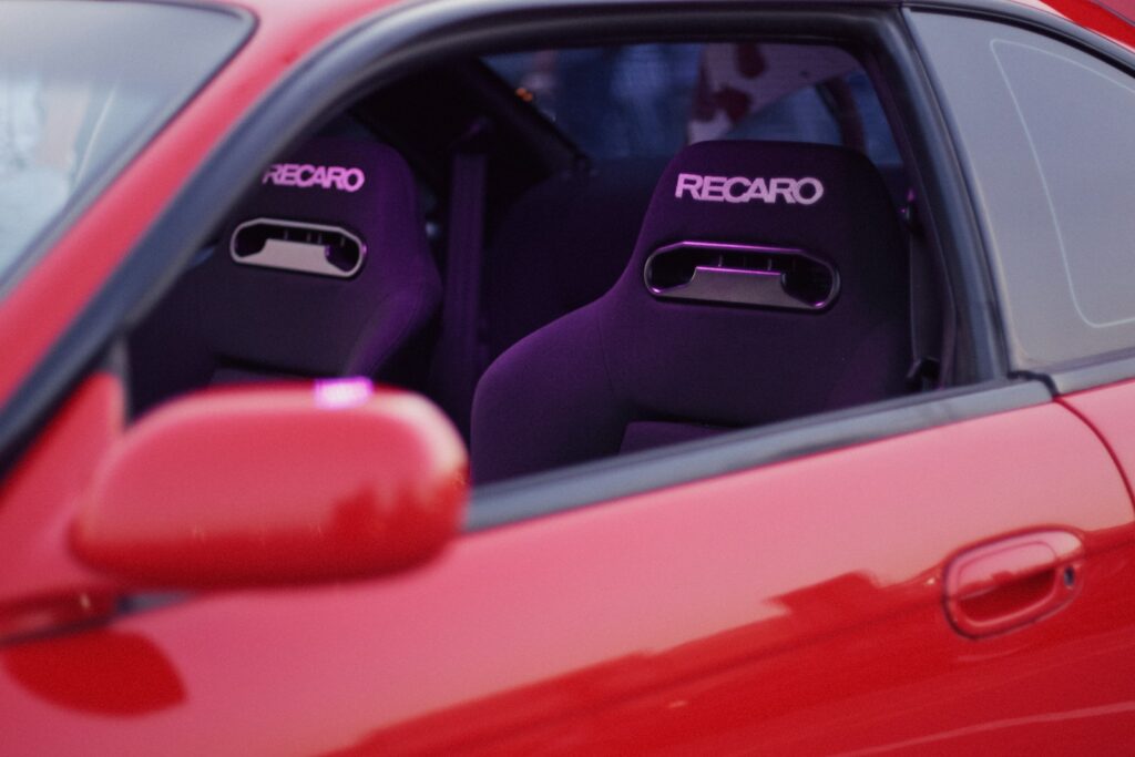 A red car with purple seats in it