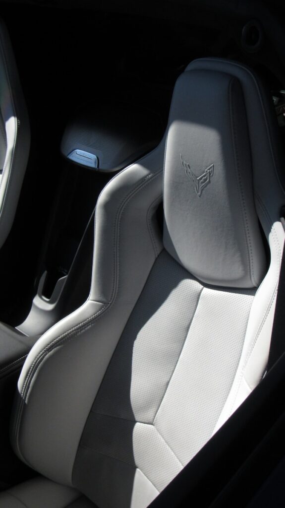 the interior of a car with white leather