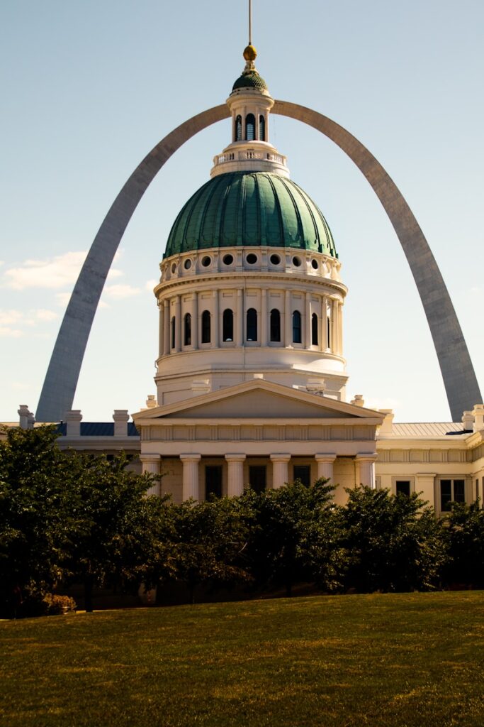 a large white building with a green dome
