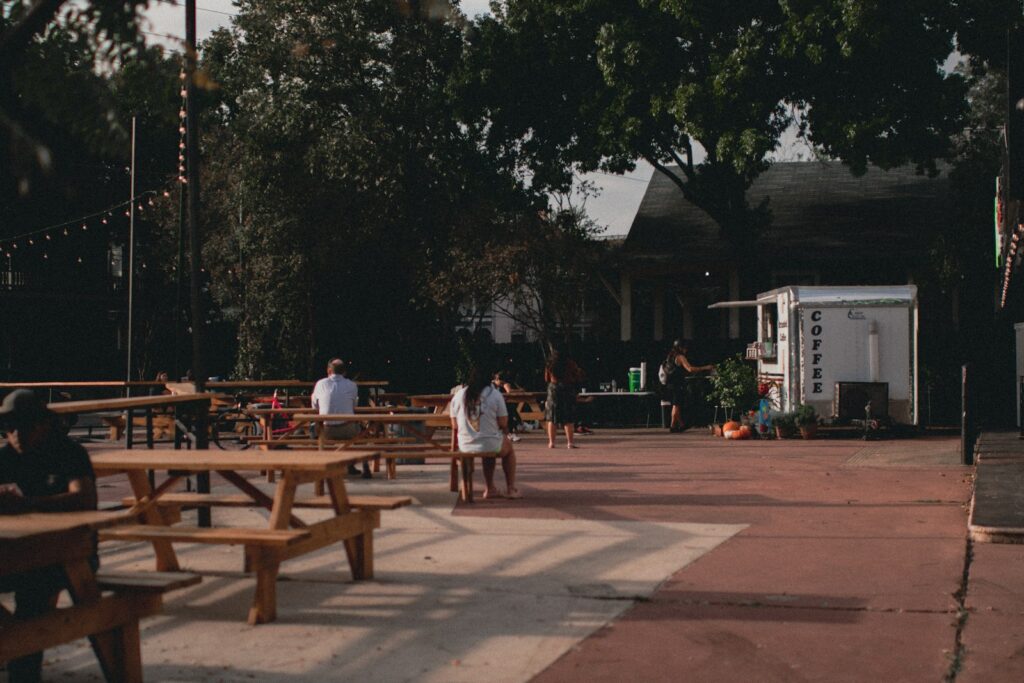 A group of people sitting at picnic tables