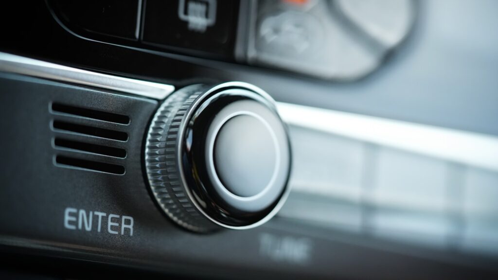 the control panel of a car with a button on it