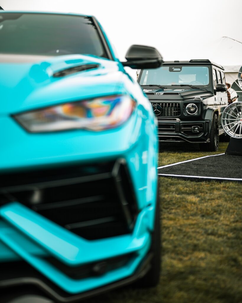 Two luxury cars parked on grass